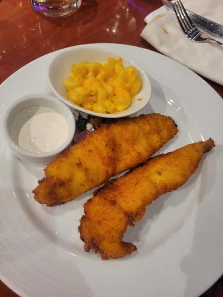 fish and mac and cheese on a white plate